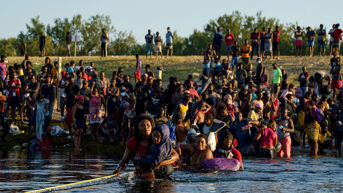 Haitian migrants cross the Rio Grand river into the U.S.