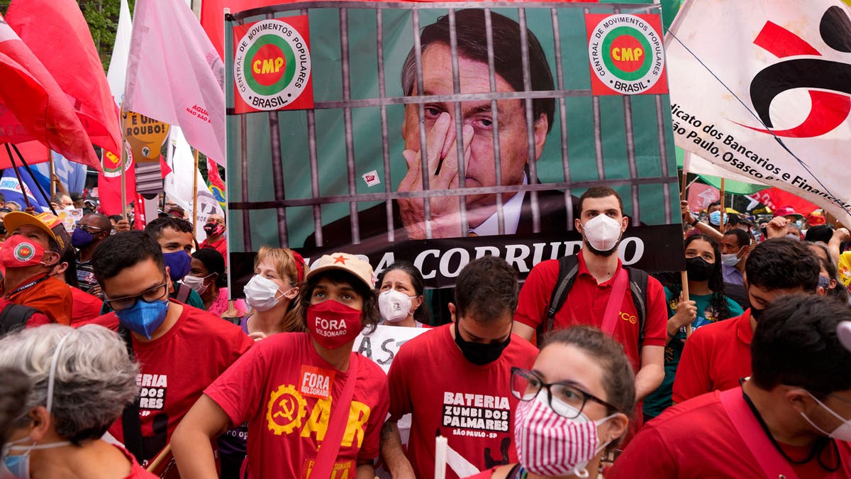Demonstrators gather during a protest against Brazilian President Jair Bolsonaro, calling for his impeachment over his government handling of the pandemic and accusations of corruption in the purchases of COVID-19 vaccines in Sao Paulo, Brazil, Saturday, Oct. 2, 2021. (AP Photo/Andre Penner)