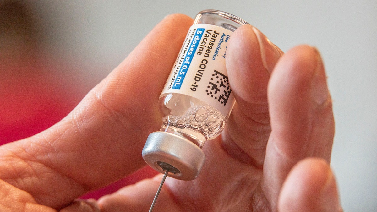 Director of Nursing Crystal Jones, 52, loads syringes with the COVID-19 vaccine.