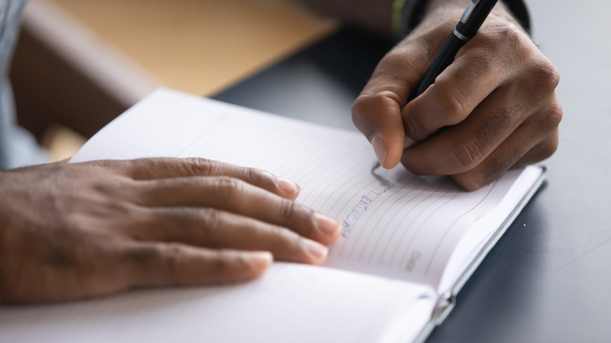 Person writing in journal