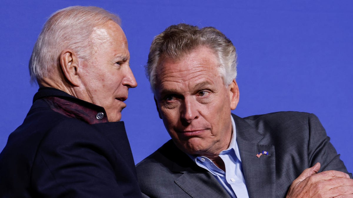 U.S. President Joe Biden and Democratic candidate for governor of Virginia Terry McAuliffe interact onstage at a rally in Arlington, Virginia, U.S. October 26, 2021. REUTERS/Jonathan Ernst