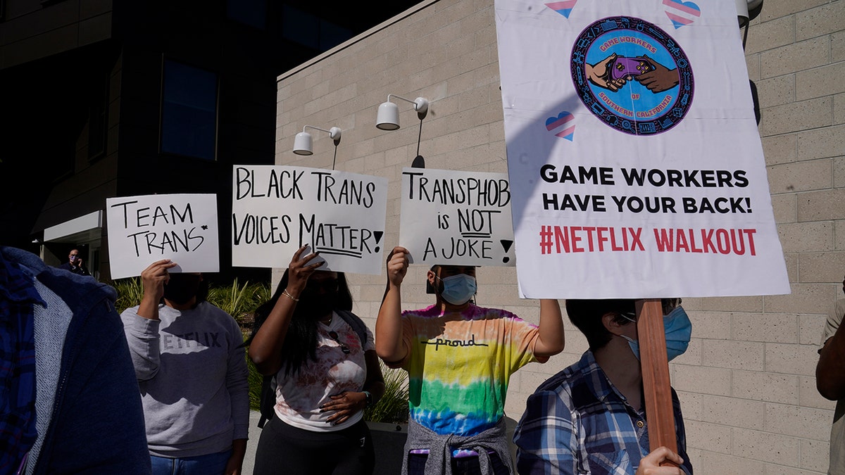 People protest outside the Netflix building in the Hollywood section of Los Angeles, Wednesday, Oct. 20, 2021. Critics and supporters of Dave Chappelle's Netflix special and its anti-transgender comments gathered outside the company's offices.