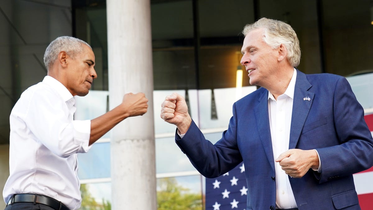 Virginia Democratic gubernatorial candidate Terry McAuliffe fist bumps former U.S. President Barack Obama during his campaign rally in Richmond, Virginia, U.S. October 23, 2021. REUTERS/Kevin Lamarque