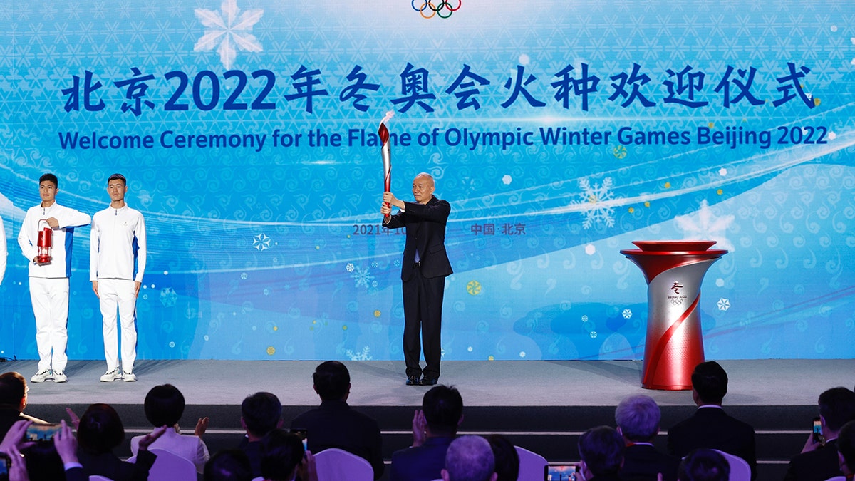 Cai Qi, chairman of the Organizing Committee of the Olympic Winter Games Beijing 2022, holds the torch during the Welcome Ceremony for the Flame of Olympic Winter Games Beijing 2022 at Beijing Olympic Tower on Wednesday.