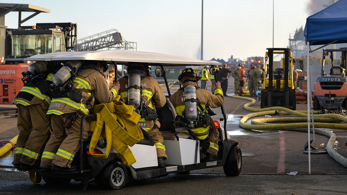 U.S. Navy sailors mobilize on a golf cart to combat a fire on board USS Bonhomme Richard (LHD 6) at Naval Base San Diego in July 2020.
