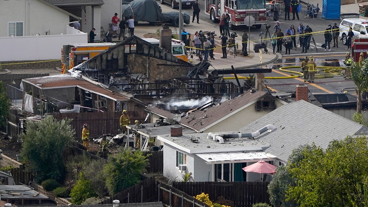 Emergency crews work a the scene of a small plane crash, Monday in Santee, Calif. (AP Photo/Gregory Bull)