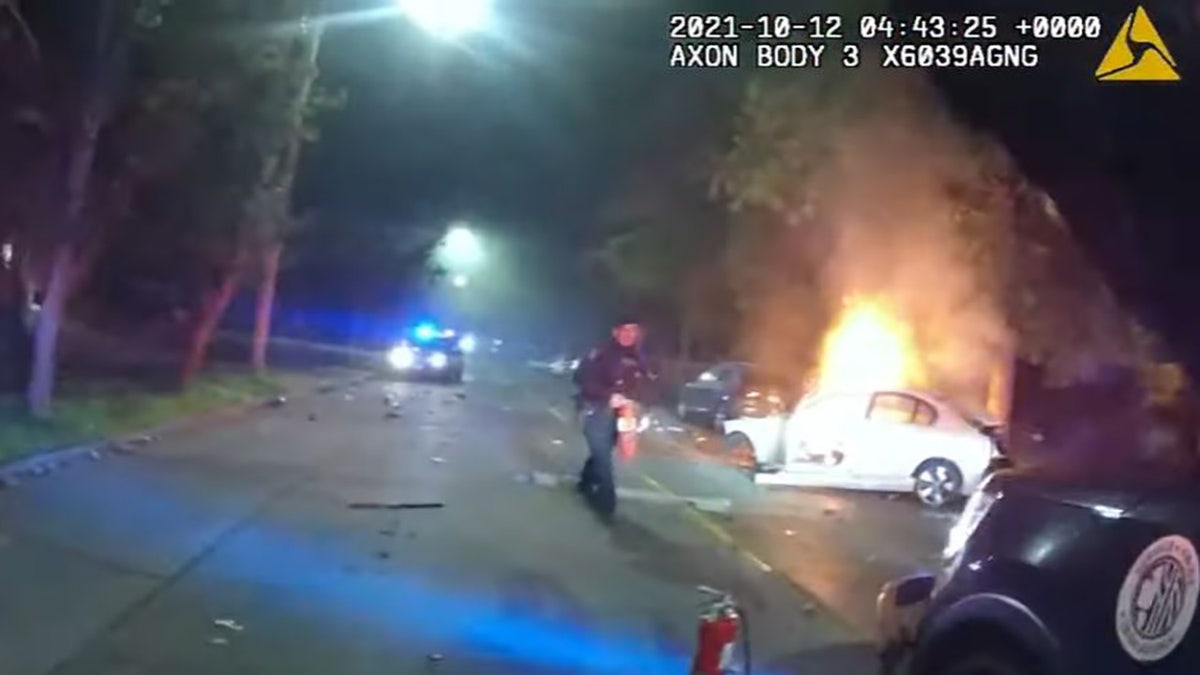 Seattle police released bodycam video of officers rushing toward the wreckage of a burning car and pulling the driver – a convicted felon – to safety 