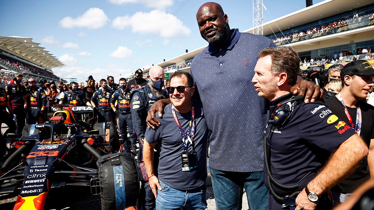 Shaquille O'Neal met with Red Bull team Principal Christian Horner (R) on the grid prior to the race.