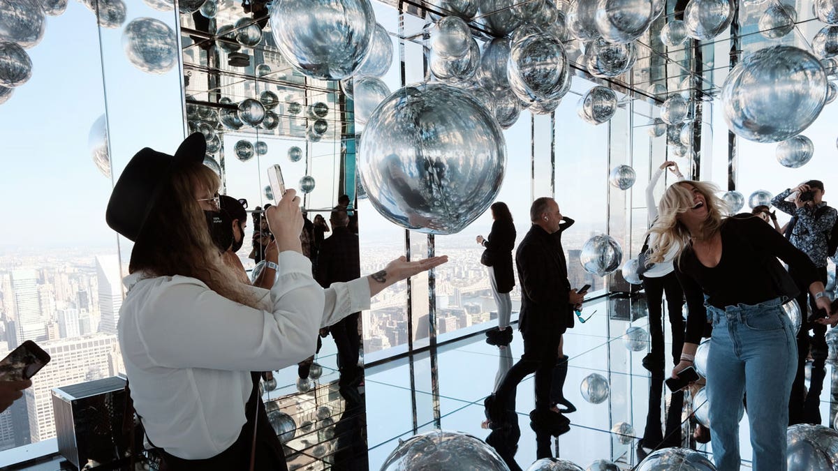 Members of the public visit the Summit One Vanderbilt observation deck on Oct. 21, 2021 in New York City. Summit One, which opened to the general public, will join the Top of the Rock, Empire State Building, One World Observatory and the Edge in Hudson Yards as New York’s latest destination for skyline views of Manhattan. It includes an outdoor terrace, a glass elevator on the exterior of the building and glass-bottom booths overlooking Madison Avenue.