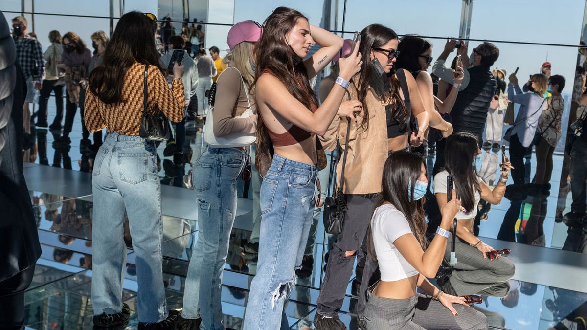 Young women take photos in the mirrors while visiting Summit One Vanderbilt as it opens to the general public Oct. 21, 2021 in New York City. Summit One Vanderbilt is an immersive experience and observation deck featuring the permanent "Air" installation by Kenzo Digital. It also includes an outdoor terrace, a glass elevator on the exterior of the building, and glass bottom booths overlooking Madison Avenue.