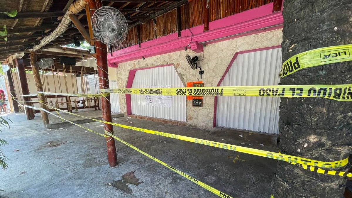 Police security tape covers the exterior of a restaurant the day after a fatal shooting in Tulum, Mexico, Friday, Oct. 22, 2021. (AP Photo/Christian Rojas)