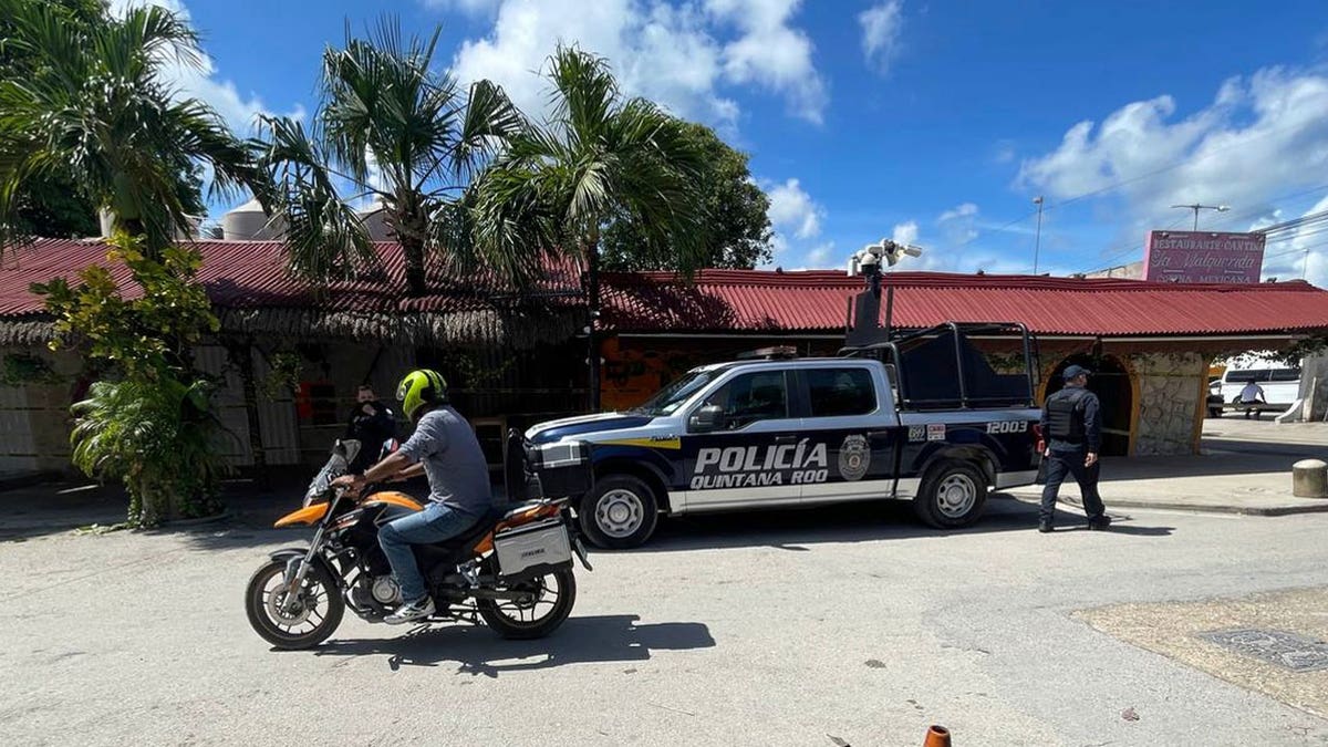 A police vehicle is parked outside the restaurant the day after a fatal shooting in Tulum, Mexico, Friday, Oct. 22, 2021. (AP Photo/Christian Rojas)