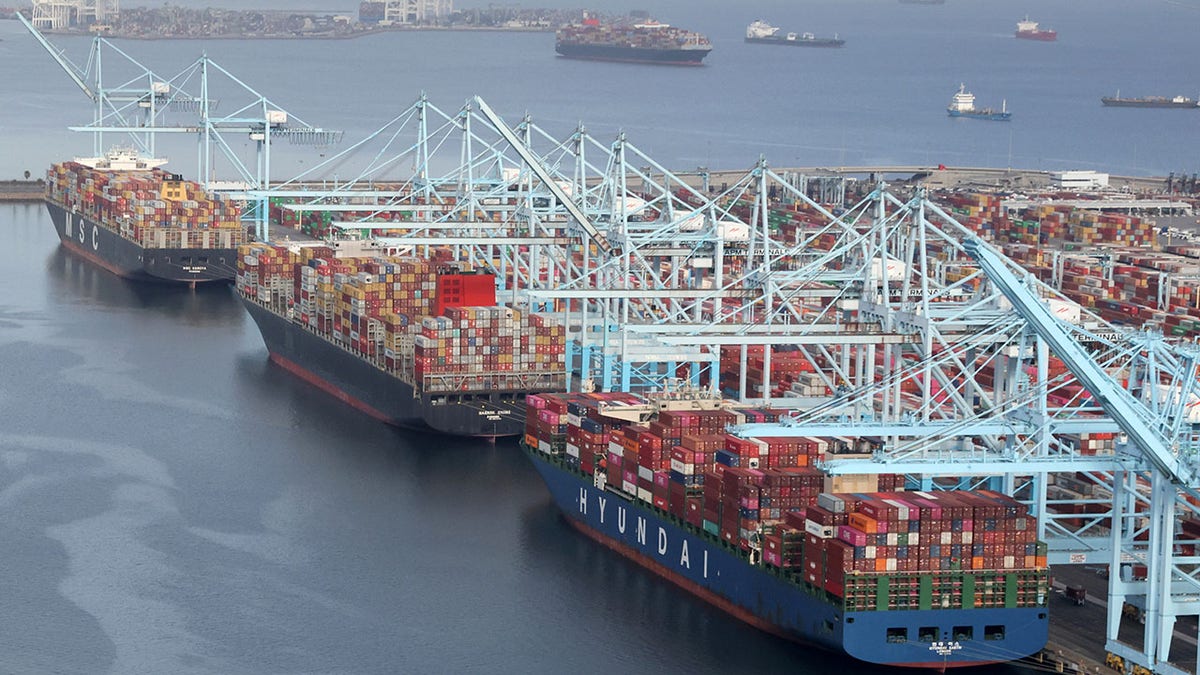 Shipping containers being unloaded from ships at a container terminal at the Port of Long Beach-Port of Los Angeles complex in April 2021.