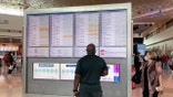 In this frame grab from cellphone video, passengers look for information on their flights, Sunday, Oct. 10, 2021, at Dallas Love Field. Southwest Airlines canceled hundreds of flights over the weekend, blaming the woes on air traffic control issues and weather. (AP Photo/Julie March)