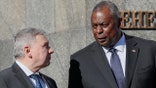 U.S. Defense Secretary Lloyd Austin, right, and Ukrainian Defense Minister Andriy Taran share a word as they attend a welcome ceremony ahead of their meeting in Kyiv, Ukraine, Tuesday, Oct. 19, 2021. (Gleb Garanich/Pool Photo via AP)