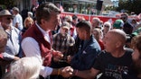 CLARKSVILLE, VIRGINIA - OCTOBER 26:  Virginia Republican gubernatorial candidate Glenn Youngkin is presented with a carved wooden cross at a campaign event outside the Blue Creek Cove on October 26, 2021 in Clarksville, Virginia. Youngkin is contesting Democratic candidate and former Gov. Terry McAuliffe in the state election that is a week away on November 2. (Photo by Anna Moneymaker/Getty Images)