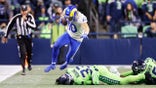 Los Angeles Rams wide receiver Cooper Kupp leaps over Seattle Seahawks safety Jamal Adams (33) during the second half of an NFL football game, Thursday, Oct. 7, 2021, in Seattle. The Rams won 26-17.