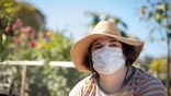 Sarah, clinical trial patient, in her garden. (John Lok | UCSF 2021)