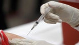 FILE - In this Thursday, Jan. 23, 2020, file photo, a patient receives an influenza vaccine in Mesquite, Texas. Amid all the focus on COVID-19 vaccinations, U.S. health experts have another plea: Don’t skip your flu shot.  With U.S. schools and businesses reopened, international travel resuming and far less masking this fall, flu is likely to make a comeback.  (AP Photo/LM Otero, File)