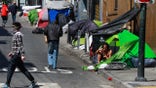 SAN FRANCISCO, CA - MAY 6: Homeless people gather on Willow Street in the Tenderloin on Wednesday, May 6, 2020 in San Francisco, California. San Francisco city government and homeless advocates sought to reduce the risk of coronavirus exposure in the homeless encampments by moving the homeless out of their tents and into vacant hotels. But that action has triggered an influx of new homeless from neighboring cities, hoping to receive the same treatment. (Gabrielle Lurie/The San Francisco Chronicle via Getty Images)