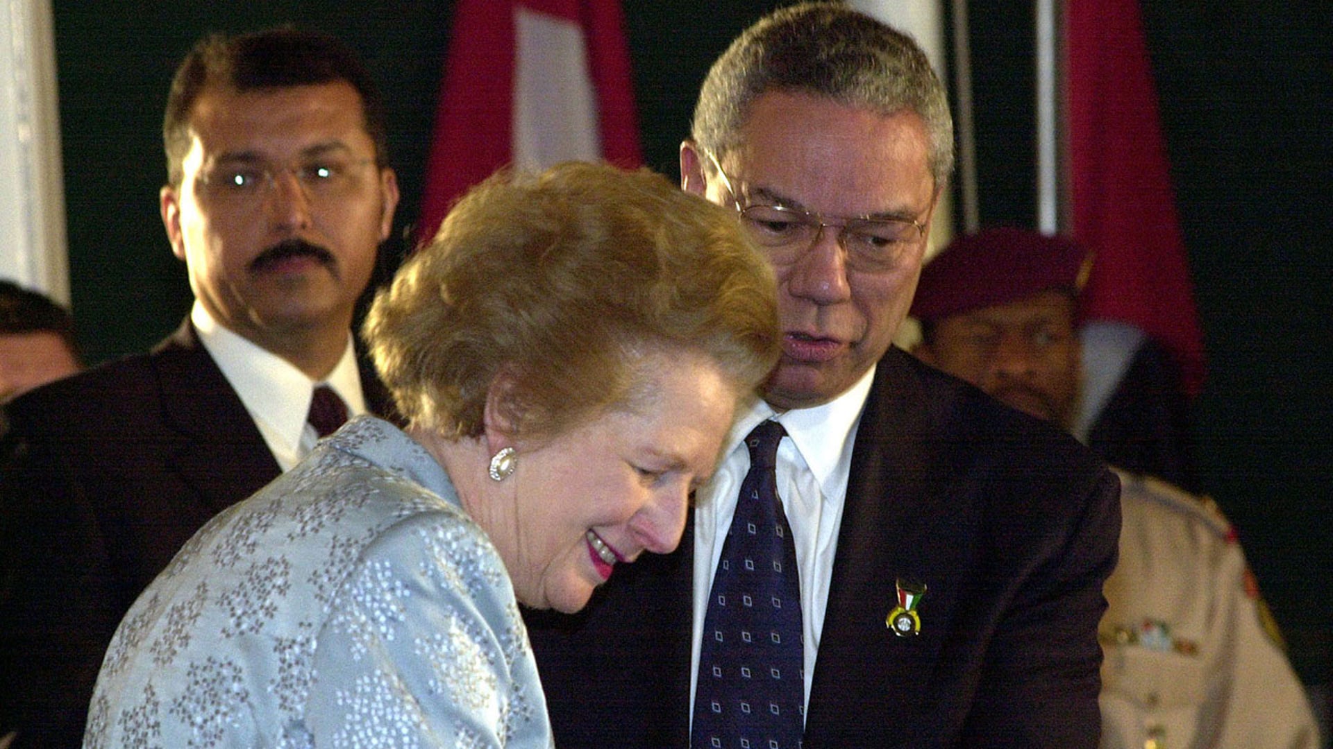 U.S. Secretary of State Colin Powell and former British Prime Minister Baroness Margaret Thatcher attend a flag raising ceremony in Kuwait to mark its 40th National Day and the 10th anniversary of liberation from Iraq's seven-month occupation. Thousands of people, including government officials,