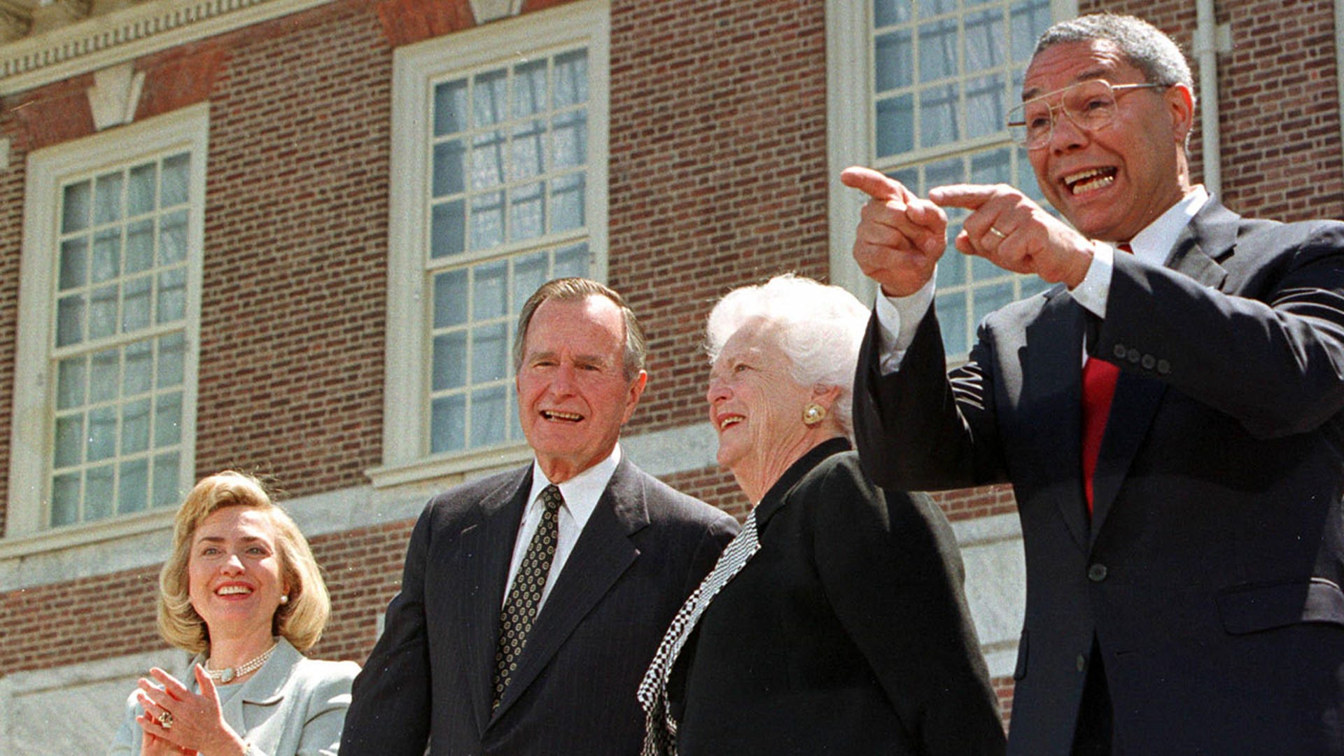 Summit general chairman Colin Powell (R) points to the audience thanking people for their support as he stands with first lady Hillary Rodham Clinton (L), former President and first lady George and Barbara Bush outside historic Independence Hal, during closing ceremonies for the President's Summit for America's Future in Philadelphia, April 29. Powell called the three-day summit, organized to draw attention to America's social youth and support system, a success. VOLUNTEER