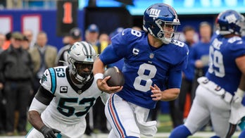 Jones passing and catching, Giants D spark win over Panthers