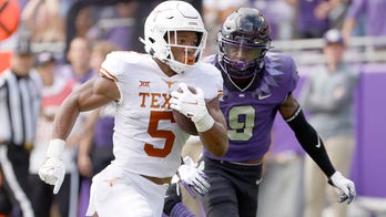 Robinson runs for 216 yards, 2 TDs as Texas beats TCU 32-27