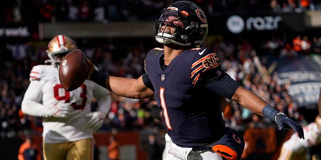 Chicago Bears quarterback Justin Fields begins to celebrate his touchdown against the San Francisco 49ers during the second half of an NFL football game Sunday, Oct. 31, 2021, in Chicago.