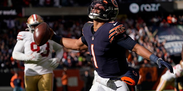 Chicago Bears quarterback Justin Fields begins to celebrate his touchdown against the San Francisco 49ers during the second half of an NFL football game Sunday, Oct. 31, 2021, in Chicago.