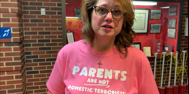 Elizabeth L. Schultz, a member of the Fairfax County School Board for 8 years, wearing a "Parents are not domestic terrorists" t-shirt.