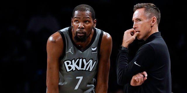 Brooklyn Nets forward Kevin Durant talks to coach Steve Nash during the Indiana Pacers game, Oct. 29, 2021, in New York.