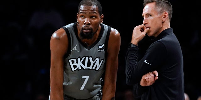 Brooklyn Nets forward Kevin Durant talks with coach Steve Nash during an Indiana Pacers game in New York on Oct. 29, 2021.