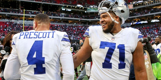 Nov 18, 2018; Atlanta, GA, USA; Dallas Cowboys quarterback Dak Prescott (4) and offensive tackle La'el Collins (71) celebrate after a game against the Atlanta Falcons at Mercedes-Benz Stadium. Mandatory Credit: Brett Davis-USA TODAY Sports