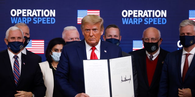 U.S. President Donald Trump signs an executive order on vaccine distribution during an Operation Warp Speed Vaccine Summit at the White House in Washington, U.S., December 8, 2020. REUTERS/Tom Brenner