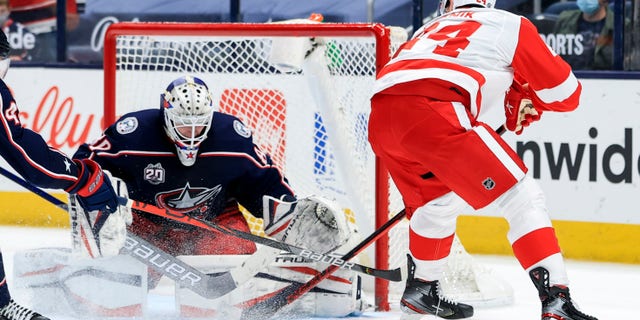 Columbus Blue Jackets goaltender Matiss Kivlenieks (80) makes a save in net against Detroit Red Wings right wing Richard Panik (24) in the overtime period May 8, 2021, at Nationwide Arena in Columbus, Ohio.