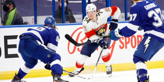 Florida Panthers right wing Owen Tippett (74) skates with the puck as Tampa Bay Lightning defenseman Mikhail Sergachev (98) defends during the second period during game six of the first round of the 2021 Stanley Cup Playoffs on May 26, 2021, at Amalie Arena in Tampa, Florida.