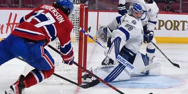 Montreal Canadiens right wing Josh Anderson (17) shoots and scores against Tampa Bay Lightning goaltender Andrei Vasilevskiy (88) during the overtime period in game four of the 2021 Stanley Cup Final on July 5, 2021, at the Bell Centre in Montreal.