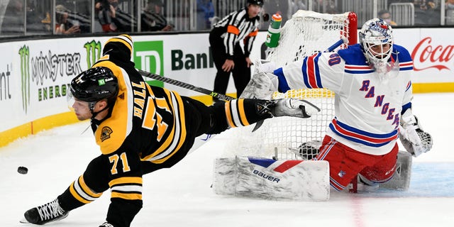 Boston Bruins left wing Taylor Hall (71) tumbles after a attempting a shot on New York Rangers goaltender Tyler Wall (80) during a shootout on Oct. 2, 2021, at the TD Garden in Boston.