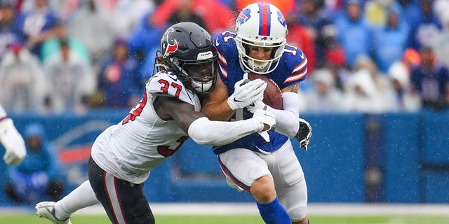 Oct 3, 2021; Orchard Park, New York, USA; Buffalo Bills wide receiver Cole Beasley (11) runs with the ball as Houston Texans running back Scottie Phillips (27) defends during the second half at Highmark Stadium.