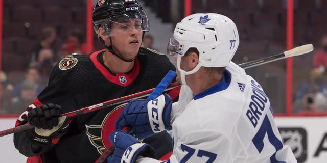 Ottawa Senators center Shane Pinto (12)battles with Toronto Maple Leafs center Adam Brooks (77) in the first period Oct. 4, 2021, at the Canadian Tire Centre in Ottawa.