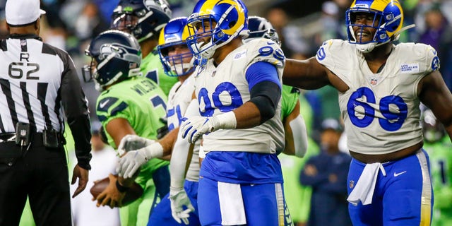 Los Angeles Rams defensive end Aaron Donald (99) and defensive tackle Sebastian Joseph-Day (69) celebrate following a play against the Seattle Seahawks during the third quarter at Lumen Field.