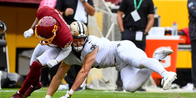 Oct 10, 2021; Landover, Maryland, USA; New Orleans Saints wide receiver Taysom Hill (7) suffers and apparent neck injury against the Washington Football Team during the first half at FedExField. Mandatory Credit: Brad Mills-USA TODAY Sports