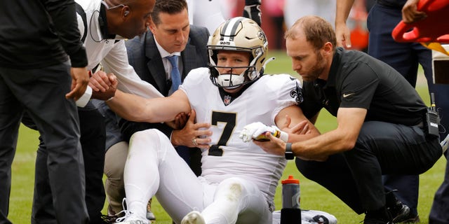 New Orleans Saints wide receiver Taysom Hill (7) is helped up after being injured against the Washington football team in the second quarter at FedExField.
