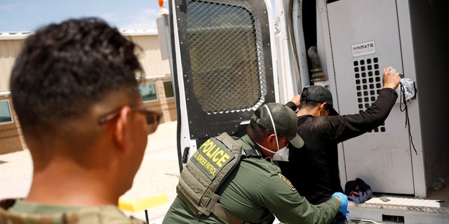 A member of the Border Patrol's Search, Trauma, and Rescue Unit (BORSTAR) observes a migrant from Central America who was detained by US Customs and Border Protection (CBP) agents after crossing into the United States from Mexico, in Dona Ana County, New Mexico, US, July 15, 2021. REUTERS/Jose Luis Gonzalez/File Photo