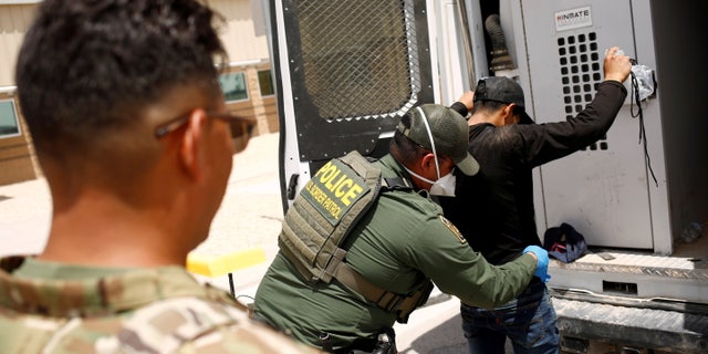 A member of the Border Patrol's Search, Trauma, and Rescue Unit (BORSTAR) observes a migrant from Central America who was detained by US Customs and Border Protection (CBP) agents after crossing into the United States from Mexico, in Dona Ana County, New Mexico, US, July 15, 2021. REUTERS/Jose Luis Gonzalez/File Photo