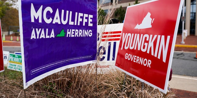 Campaign signs for Democrat Terry McAuliffe and Republican Glenn Youngkin stand together on the last day of early voting in the Virginia gubernatorial election in Fairfax, Virginia, U.S., October 30, 2021.    