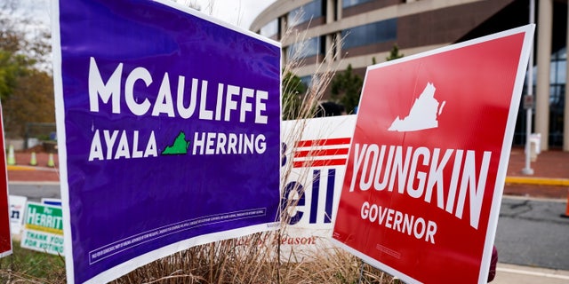 Campaign signs for Democrat Terry McAuliffe and Republican Glenn Youngkin stand together on the last day of early voting in the Virginia gubernatorial election in Fairfax, Virginia, the United States on October 30, 2021.