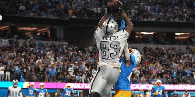 October 4, 2021;  Inglewood, California, United States;  Las Vegas Raiders tight end Darren Waller (83) catches a pass for a touchdown on the defensive back of Los Angeles Chargers Nasir Adderley (24) during the second half at SoFi Stadium.  Mandatory Credit: Kirby Lee-USA TODAY Sports