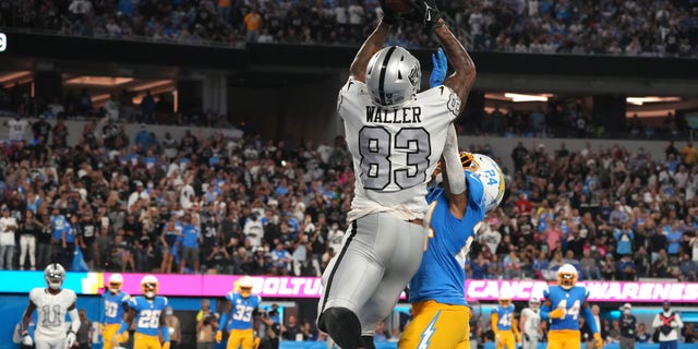 Oct 4, 2021; Inglewood, California, USA; Las Vegas Raiders tight end Darren Waller (83) catches a pass for a touchdown over Los Angeles Chargers defensive back Nasir Adderley (24) during the second half at SoFi Stadium. Mandatory Credit: Kirby Lee-USA TODAY Sports